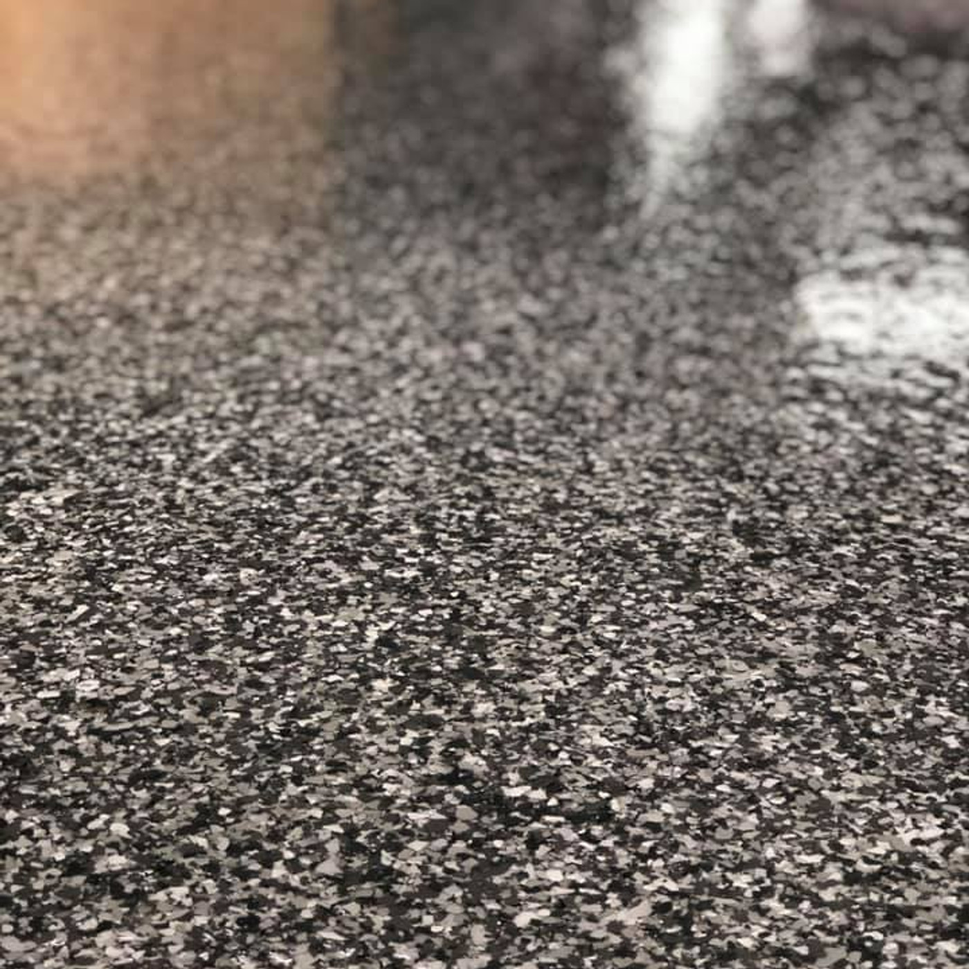 High-gloss epoxy garage floor with metallic reflector finish